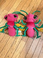 Both Miss Spider plush dolls side by side showing full bodies and colors