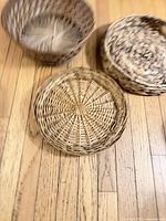 Three baskets displayed on hardwood floor
