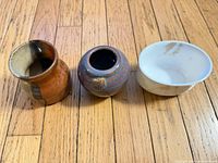 Top view of all three small ceramic jars on wood floor