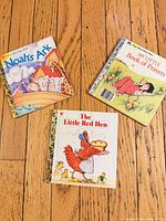 All three Little Golden Books displayed on wood floor