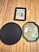 All three trays displayed: round black, rectangular Japanese scene, scalloped bird motif