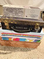 Stack of four decorative boxes showing designs and sizes