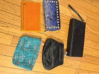 All five purses and pouches laid out on floor