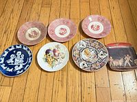 All seven plates laid out showing front designs