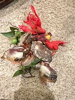 Collection of eight artificial birds grouped on carpet
