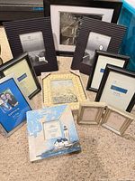 Group shot of ten new picture frames in assorted sizes and styles on carpet