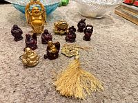 Group shot of all Buddha figurines, lotus decor and tassel on carpet
