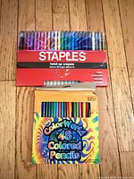Staples twist-up crayon set above ColorWorld colored pencils box
