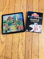 Crayola Signature tin and Prang 36-count colored pencil box on wooden floor