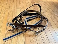 Pile of men’s belts on wooden floor