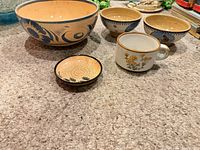 Group shot of all five ceramic pieces on carpet
