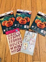 Three sealed Halloween stencil-and-sticker packs, two additional loose sticker sheets