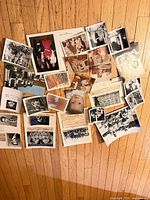 Overhead view of entire lot of assorted photographs spread on hardwood floor