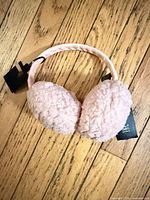 Full view of pink earmuffs showing both ear covers and headband