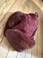 Overall view of burgundy faux fur trapper hat