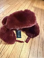 Top view of burgundy faux fur trapper hat