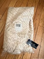 Scarf in packaging on floor