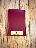 Front view of small red softcover book with Sober24.com label