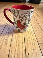 Front view of Spectrum Cardinal coffee mug displaying cardinal and vine design