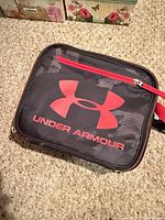 Front view showing logo, red zipper pocket, general condition