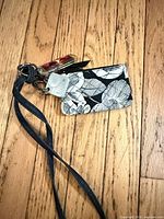 Wallet with attached lanyard on wood floor