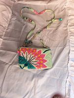 Front view of wallet with attached strap