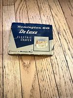 Closed retail box marked Remington 60 De Luxe Electric Shaver