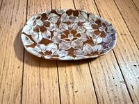 Top view of oval brown and white floral ceramic dish