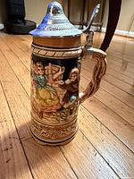 Front view showing relief figures and lid