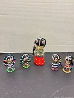 Group shot of five African beaded dolls