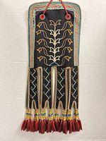 Full view of octopus bag front showing beadwork, pendant legs and tassels