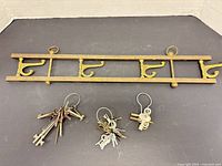 Top view of brass coat rack and three key sets