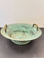 Oblique view showing overall bowl, handles, patina
