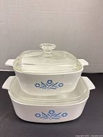Both Corning Ware casseroles stacked showing pattern and lids