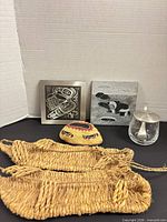 All items grouped: sandals, two trivets, woven shell, glass jar