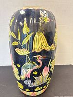 Full view of vase showing shape, glaze colour and painted motifs
