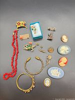 All thirteen jewellery pieces arranged on dark background