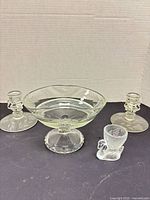 Group shot showing pair of candlesticks, footed compote, swan egg cup