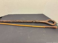 Both sticks side by side to show full length and style difference