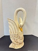 Front angled view of carved wood swan showing full form and details