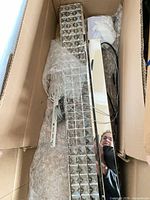 chandelier in box showing cut glass crystal rows and chrome frame