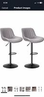 Pair of grey channel-tufted bar stools with black pedestal bases