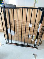 Main black metal gate panel leaning against carton