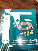 Front of Smart Choice dishwasher waterline install kit box