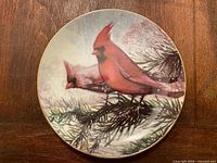 Front view of porcelain plate showing cardinal artwork and gold rim