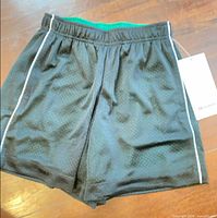 Front view of black mesh shorts showing overall design