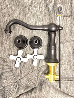Faucet spout, two escutcheons, two cross handles displayed