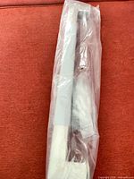 Grab bar in sealed plastic sleeve, full length view