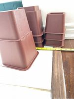 Stack of reddish-brown risers beside measuring tape