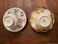 Undersides of both saucers showing Royal Albert backstamps